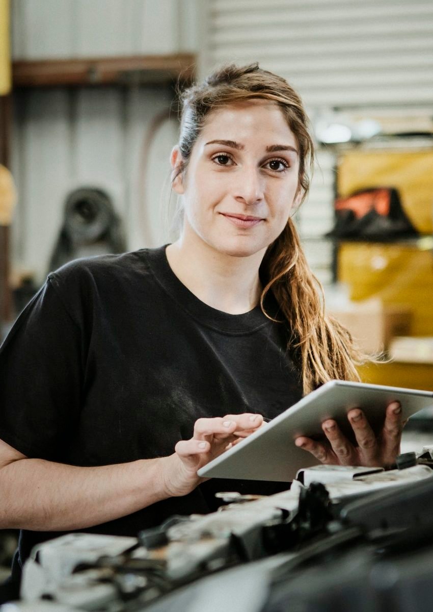 happy female car mechanic e1651039485976.jpg
